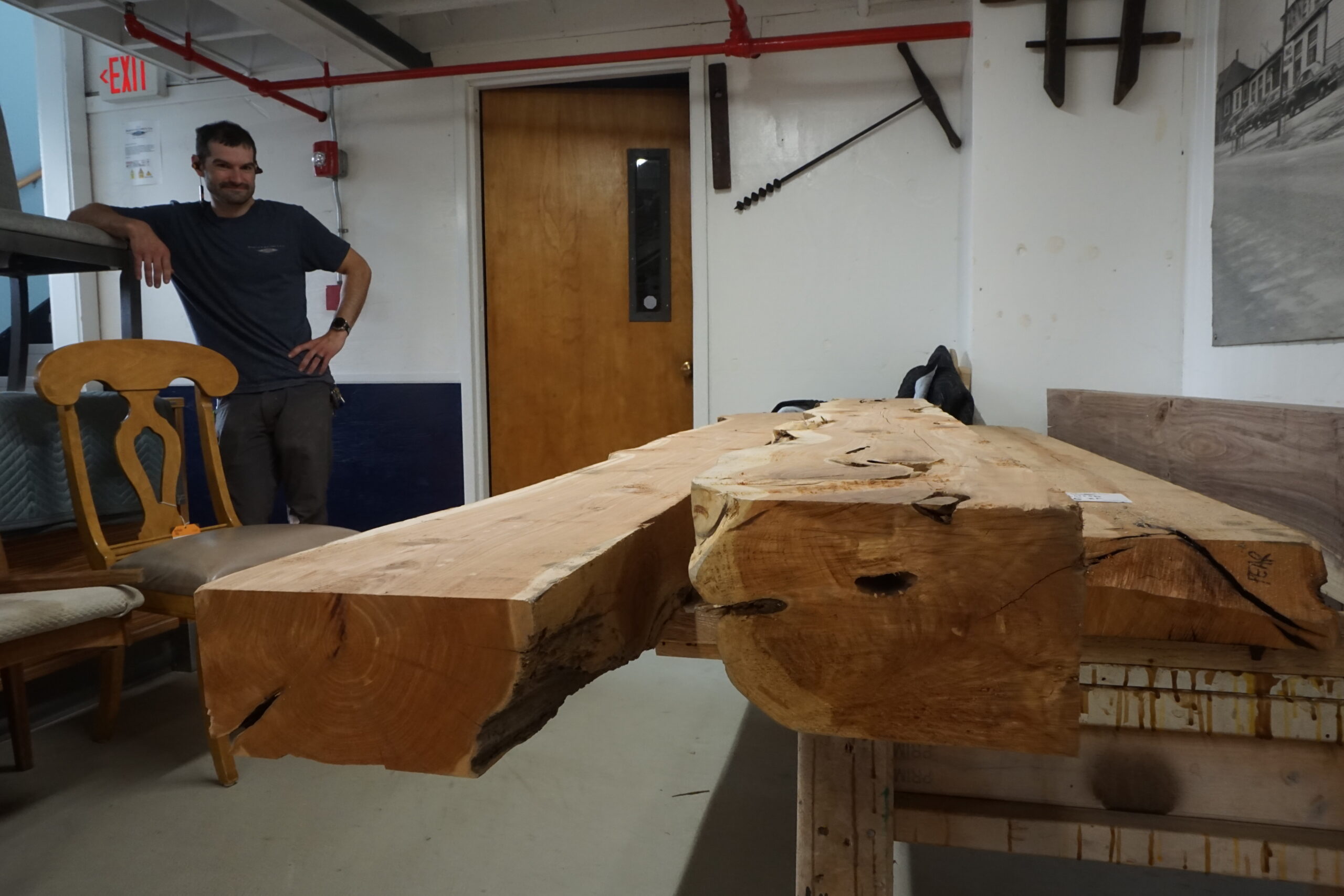 Barney & Carey employee looking at rough lumber