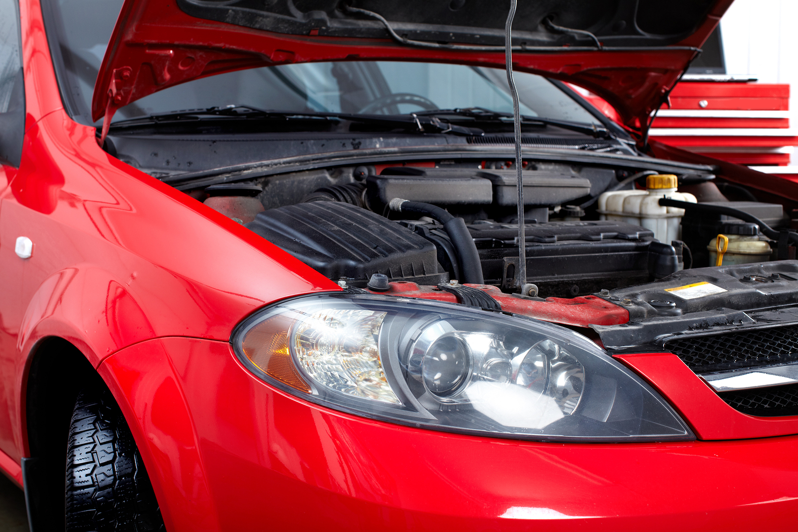 Car with open hood in auto repair shop. Car with open hood in auto repair shop.