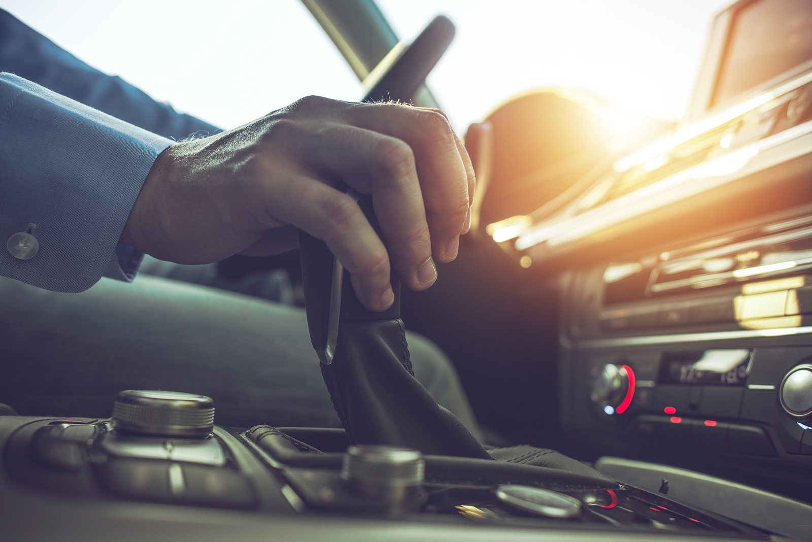 transmission Car Driving Concept. Driver Shifting To Drive Mode. Hand on Transmission Stick Closeup