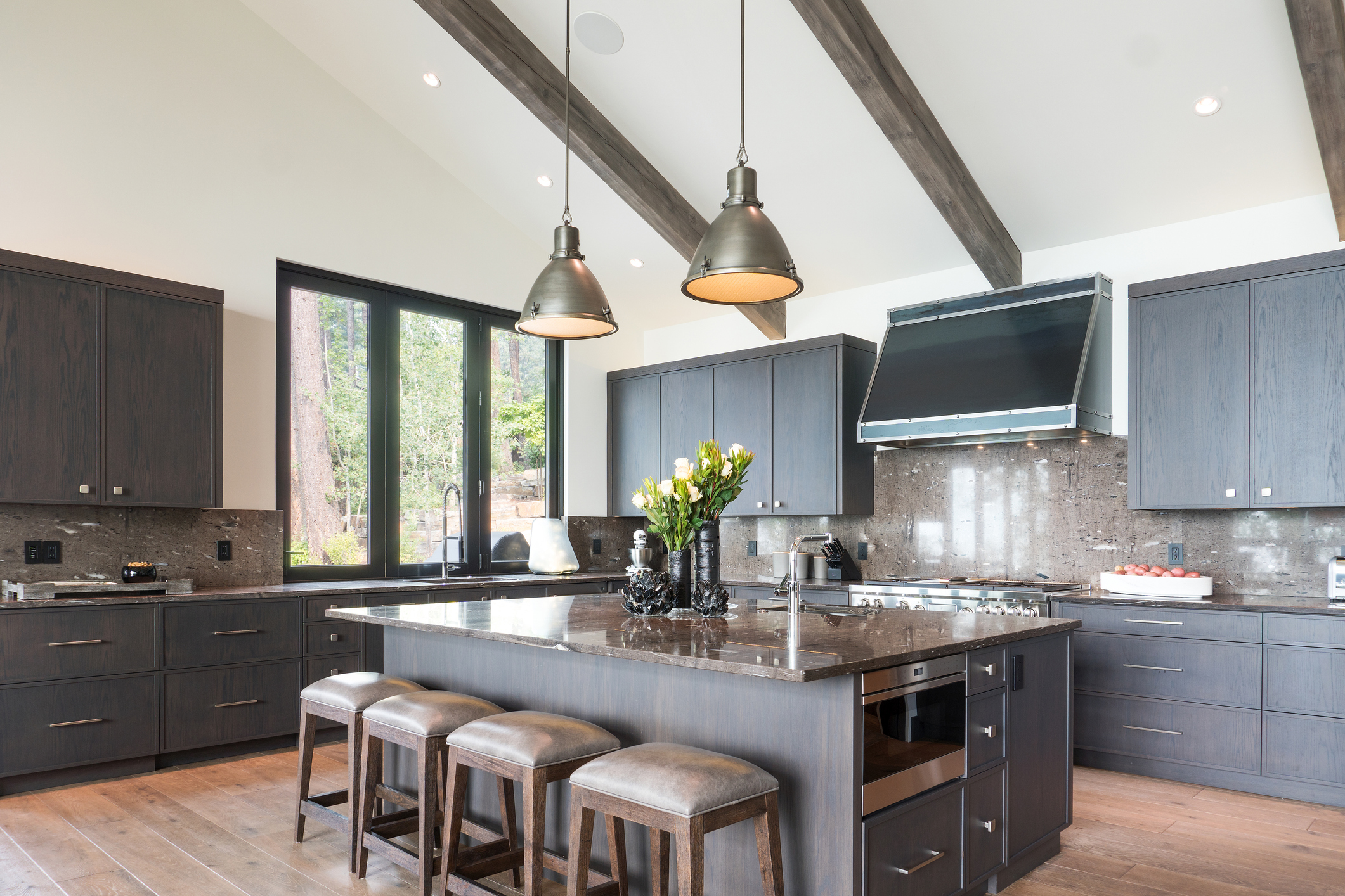 Kitchen island with four stools and two pendant lights above
